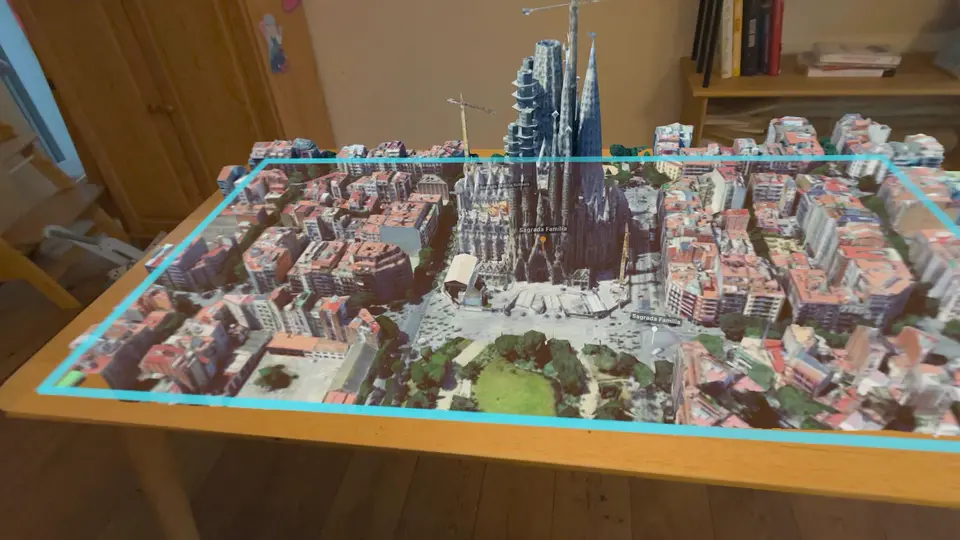 Barcelona as a 3D map across a wooden table, outlined in cyan