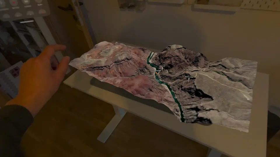 A hand turning the Grand Canyon terrain